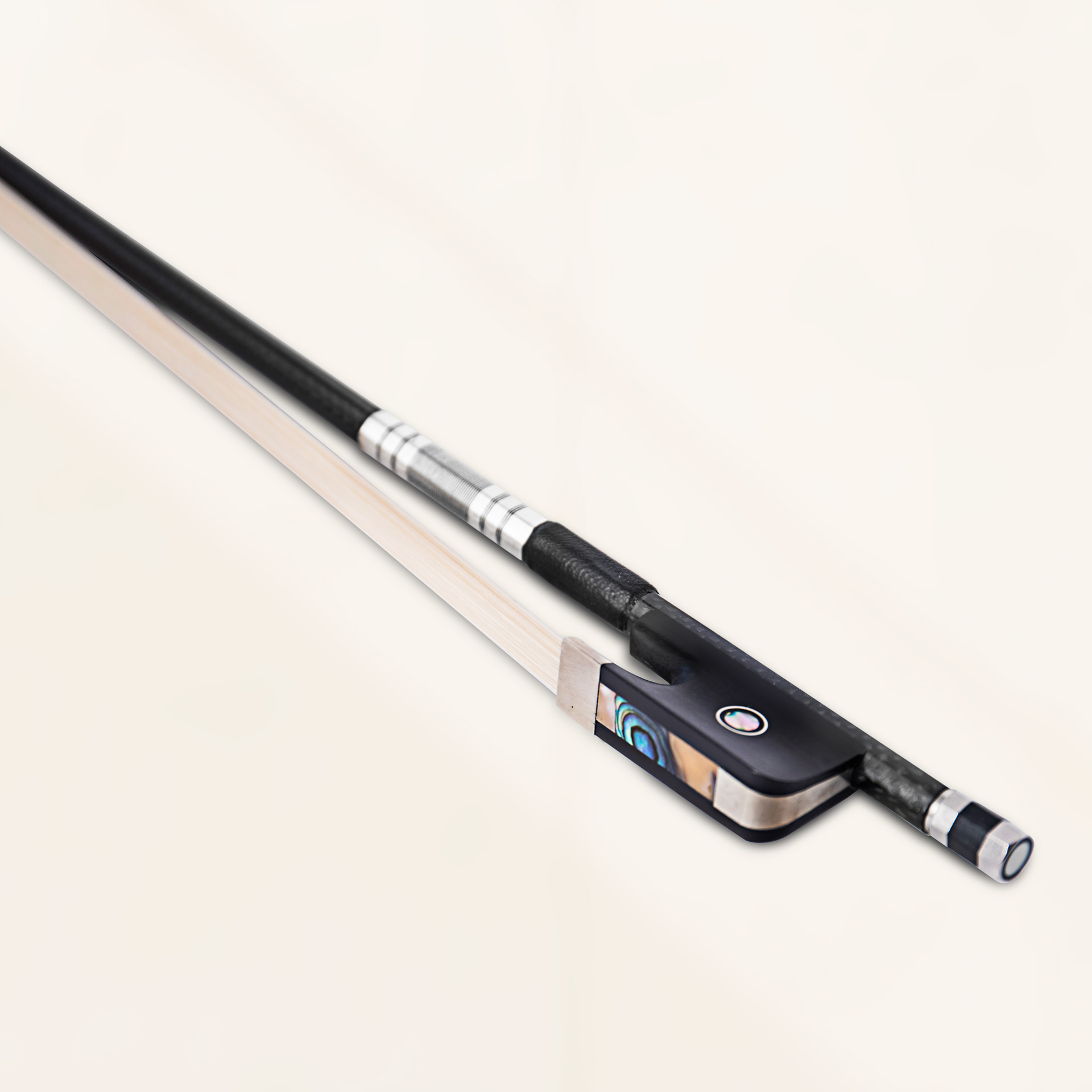 Angled close-up view of cello - sartory bow in black grey weave finish showing carbon fiber weave and bronze winding